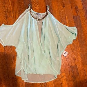Gorgeous top in sheer fabric with neckline details.